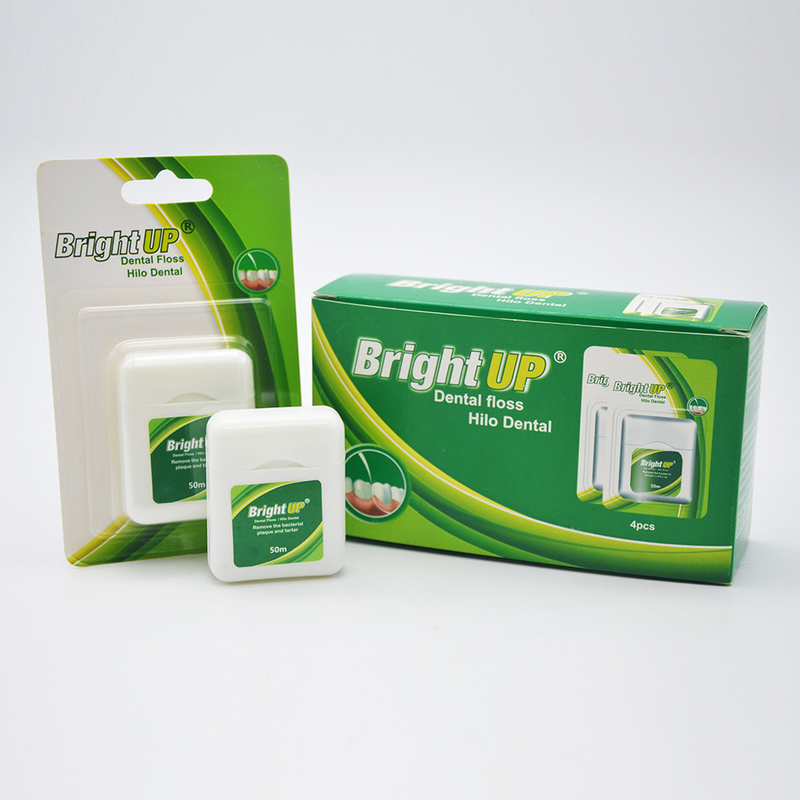 La caja biodegradable herbaria de la seda dental o la seda dental escoge cuidado oral le guarda sonrisa