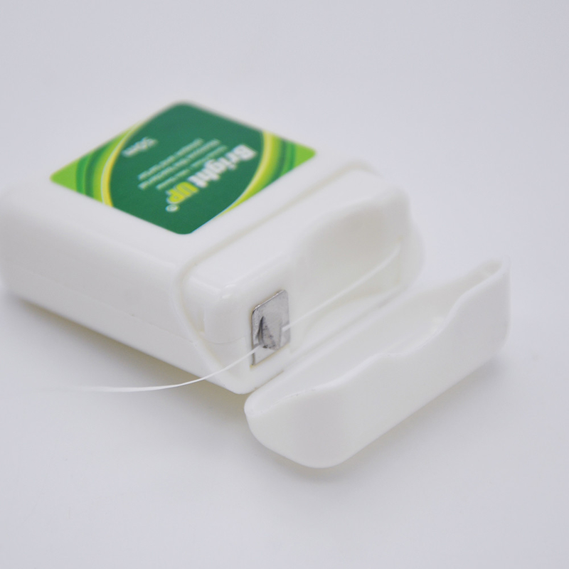 La caja biodegradable herbaria de la seda dental o la seda dental escoge cuidado oral le guarda sonrisa
