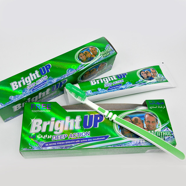 Brillante encima de la crema dental oral de restauración del cuidado del sabor de la menta genérica con el cepillo de dientes libre